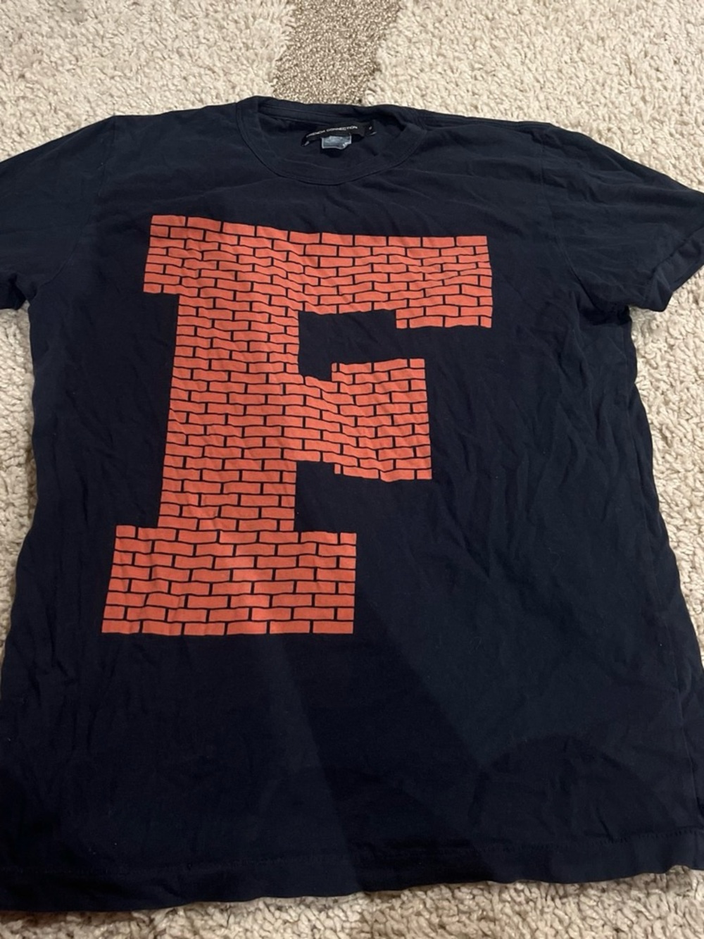 French Connection Black Tee with Brick-Pattern Red 'F' Graphic